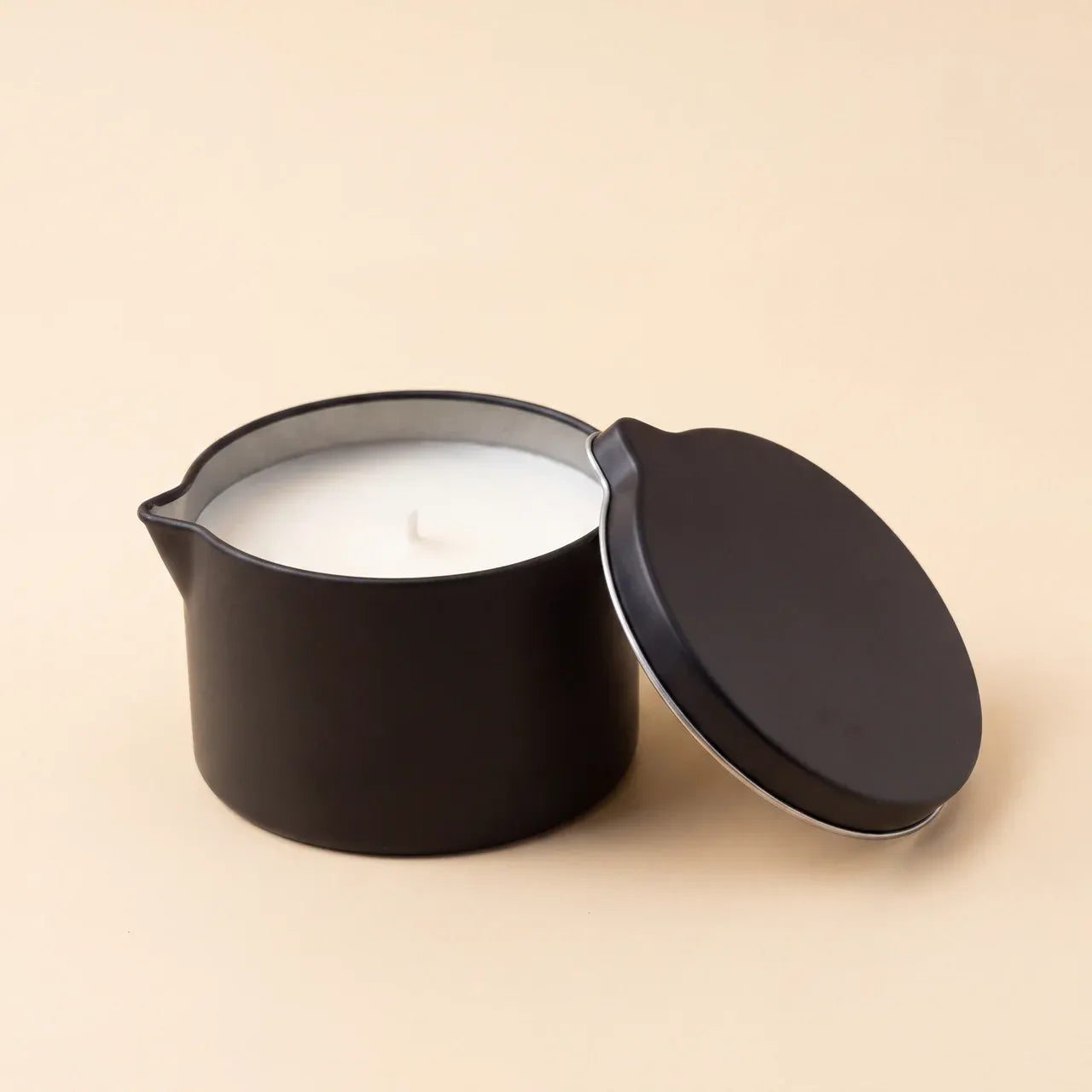 Unlit CareHush massage candle with lid